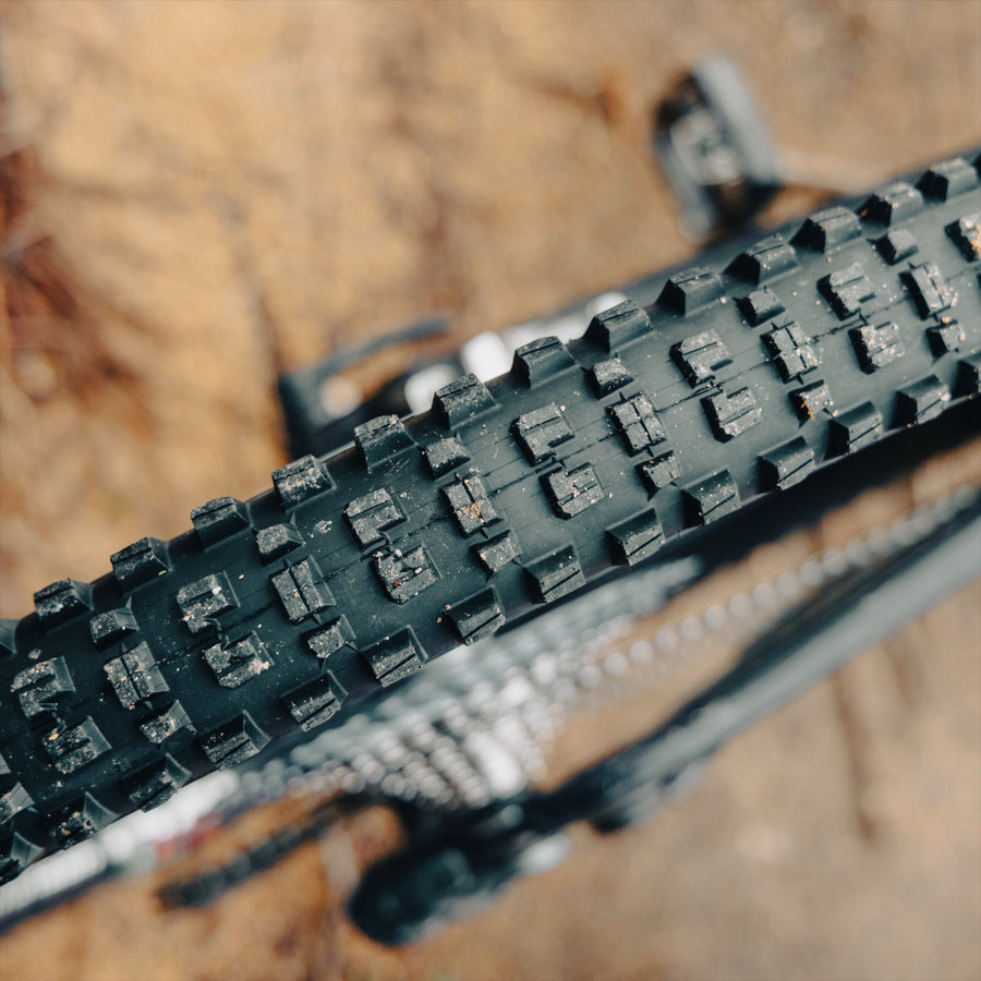 A Grappler tire tread packed with mud on the trail