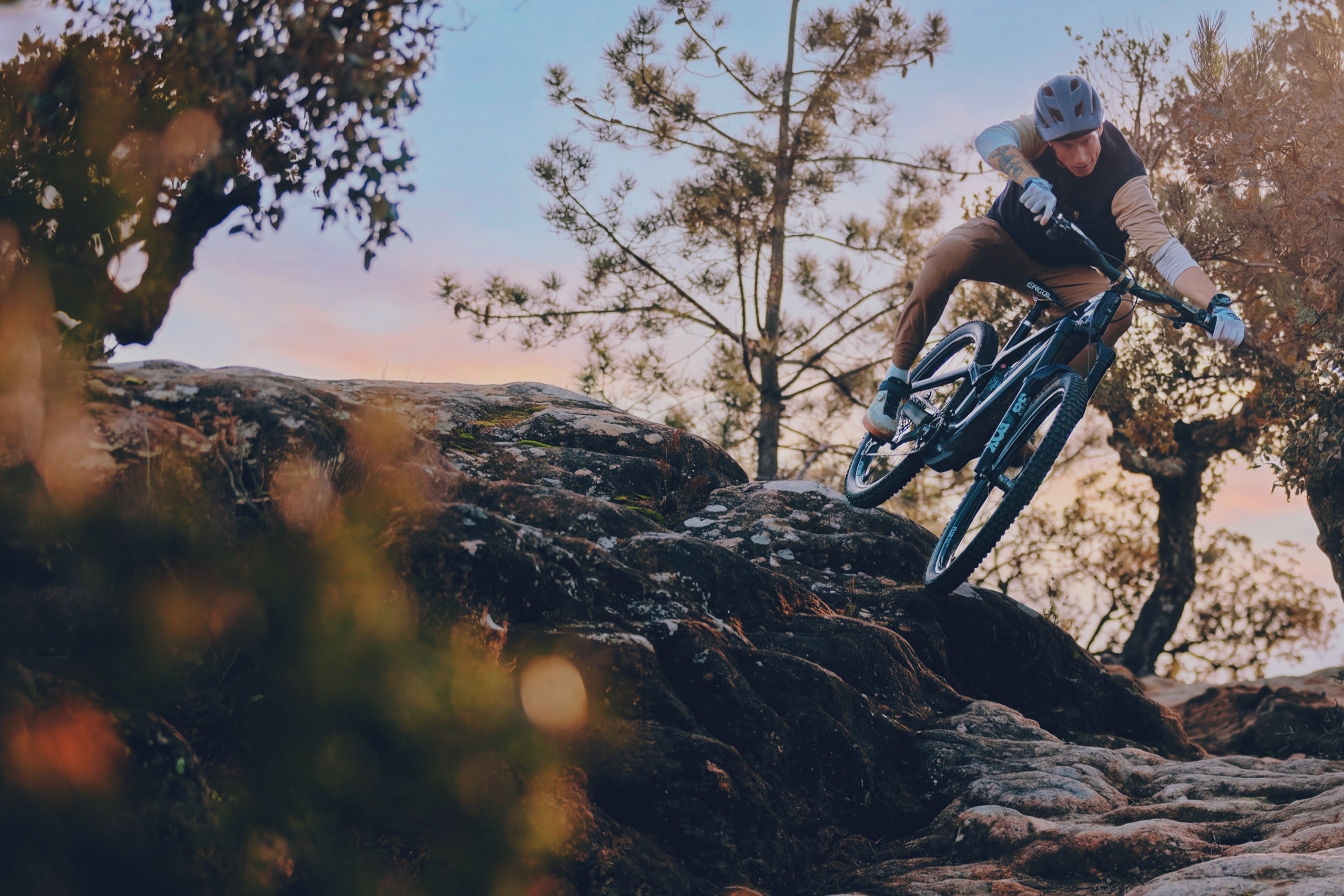 Jasper Jauch dropping into a rock slab on a bike running Sidekick hubs.