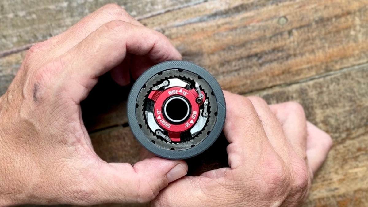 Hands holding a 3D printed Sidekick freehub prototype marked WIDE 18, MED 15 and SHORT 12 degrees